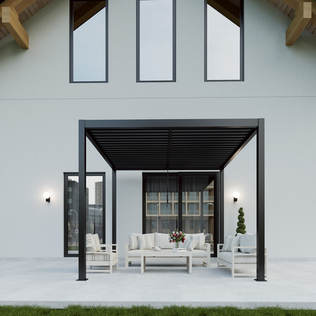 Modern outdoor patio area with white furniture and a black pergola in front of a house.
