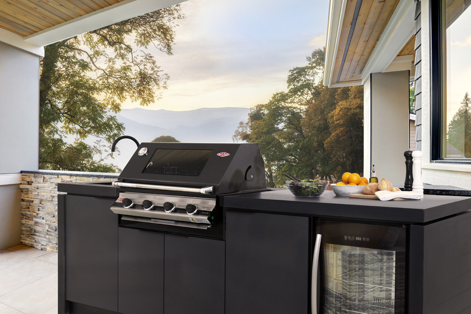 Black outdoor grill on a patio with scenic view