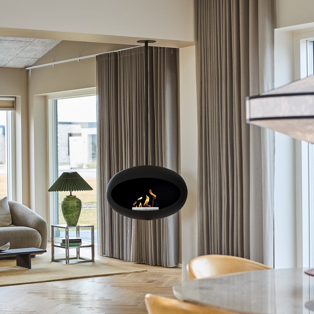 Modern living room with a fireplace, dining table, and large windows.